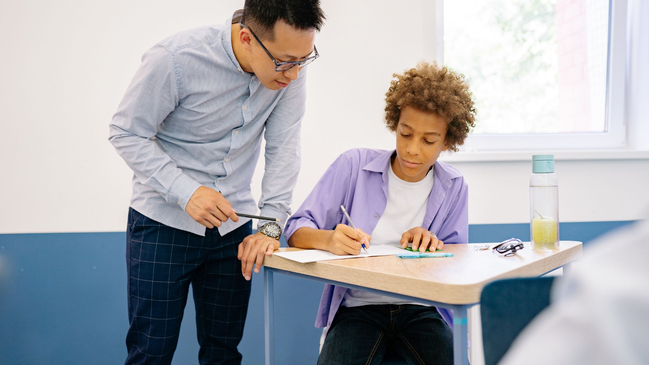 Teacher and student at a desk
