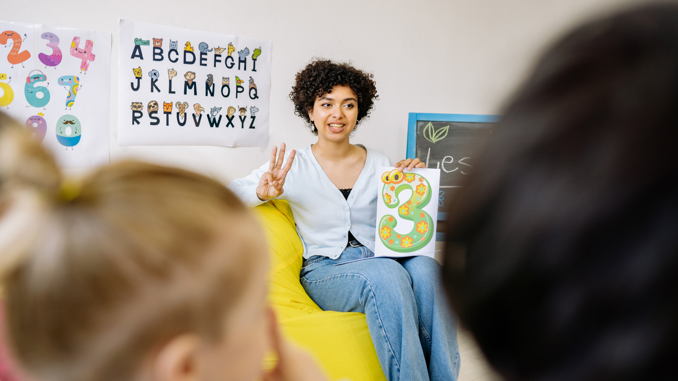 A teacher teaching her young students